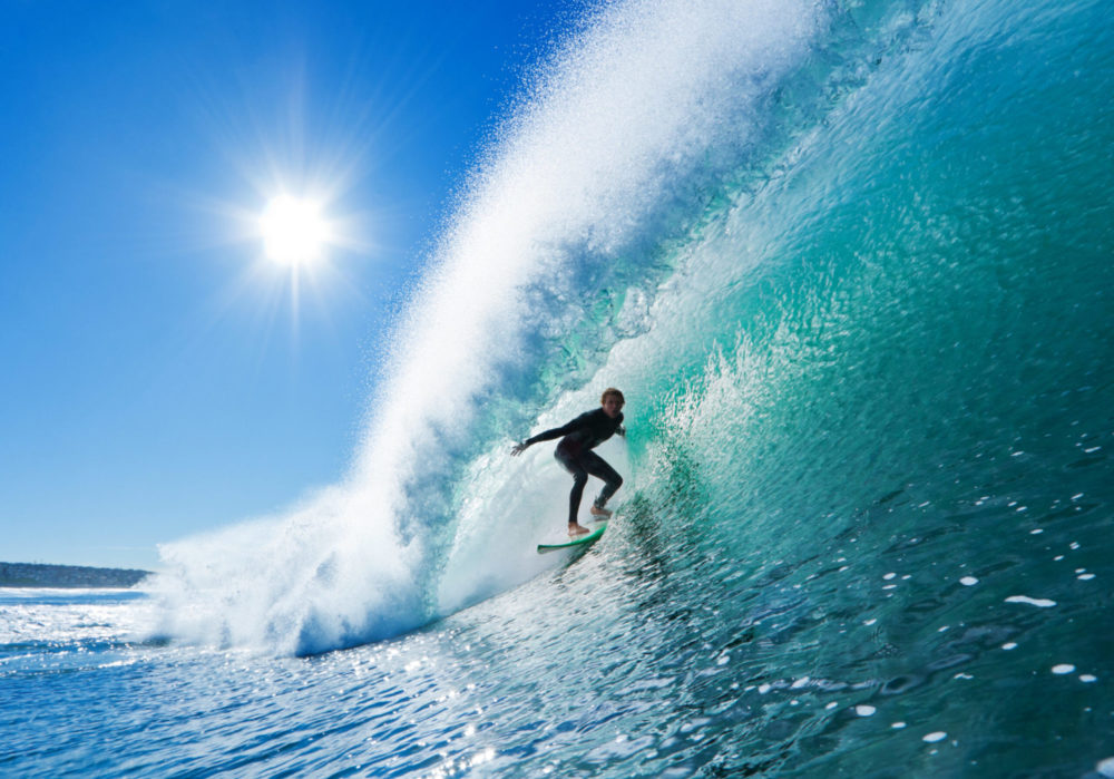 Surfer on Blue Ocean Wave in the Barrel